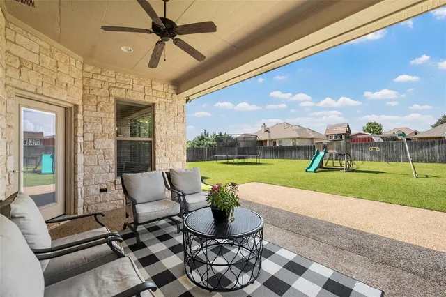 a building outdoor space with patio furniture and garden