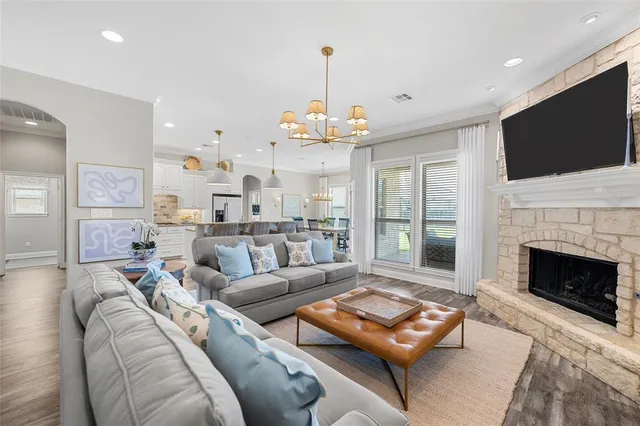 a living room with furniture a flat screen tv and a fireplace