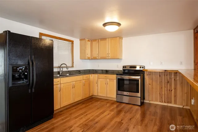 a kitchen with stainless steel appliances granite countertop a refrigerator and a sink