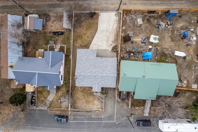 a view of a house with wooden deck and furniture