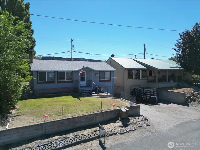a view of a house with wooden fence