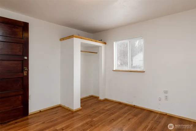 an entryway with fireplace and wooden floor