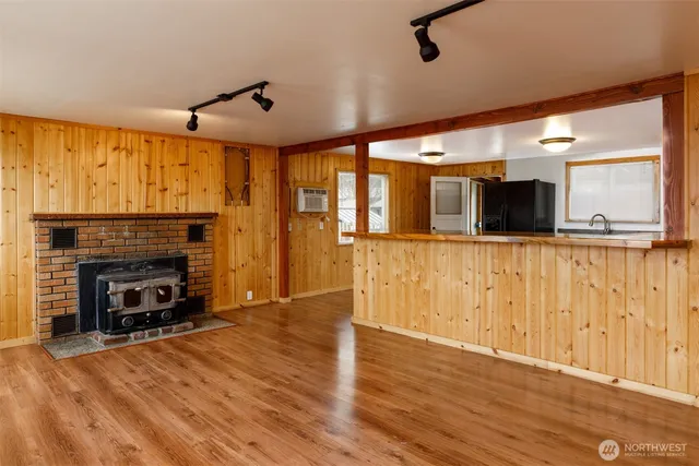 a living room with stainless steel appliances granite countertop furniture and a fireplace