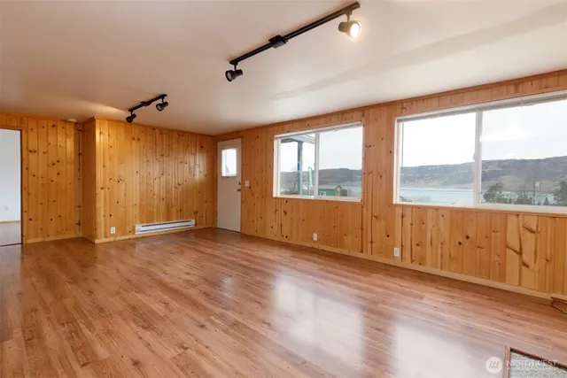 a view of a kitchen with wooden floor and a sink