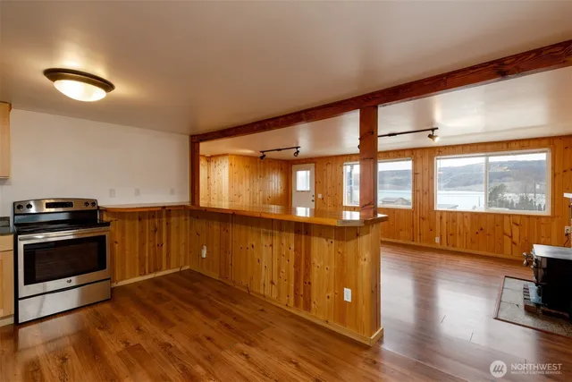 a view of a room with wooden floor and windows