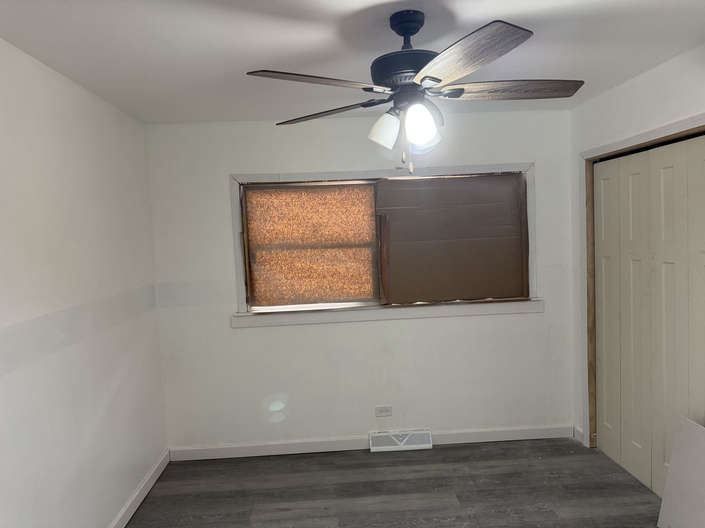 1104 East 156th Place Dolton, IL 60419 - Photo 5 of 14 an empty room with wooden floor ceiling fan and windows