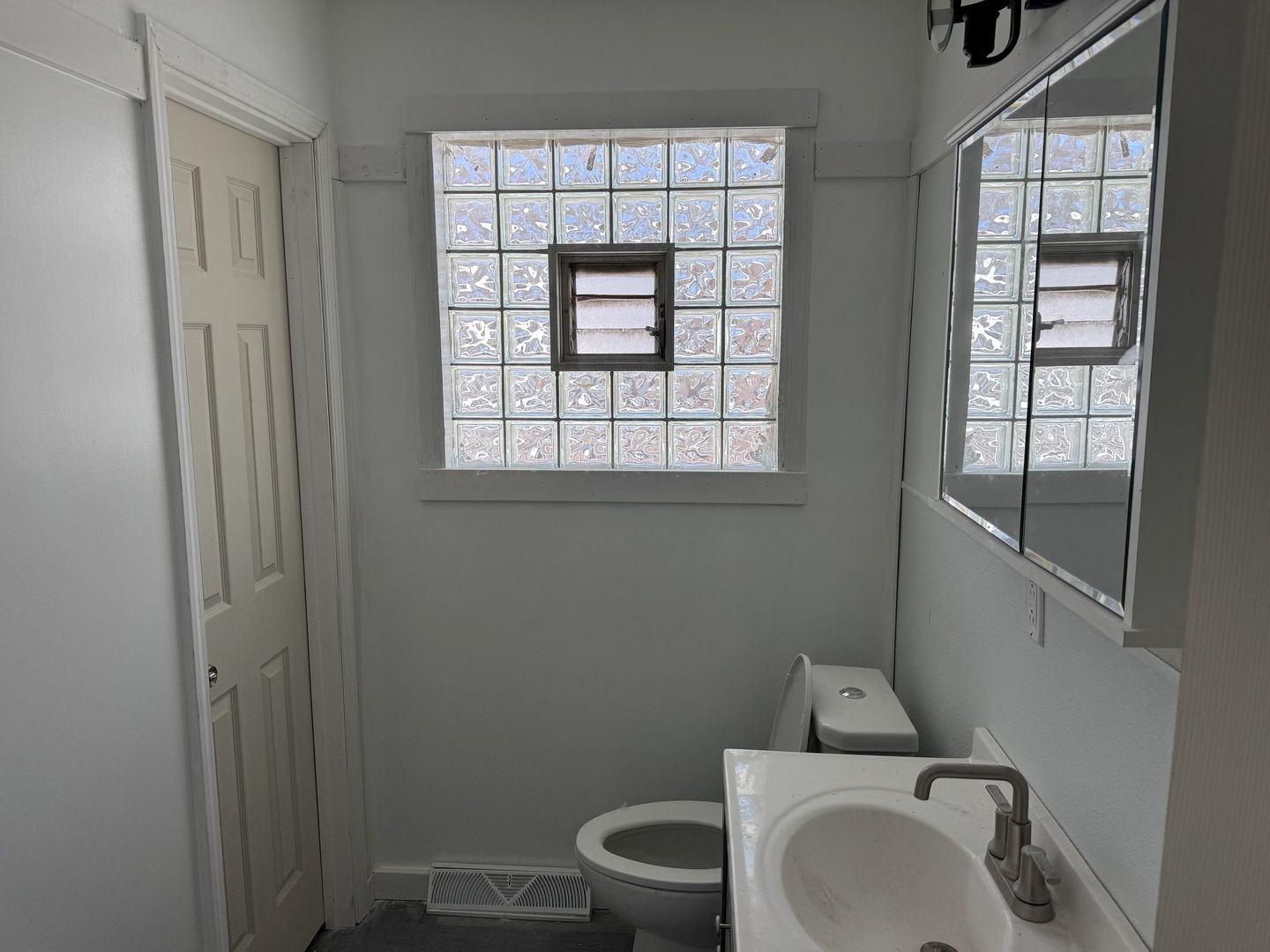 1104 East 156th Place Dolton, IL 60419 - Photo 7 of 14 a bathroom with a toilet sink and window