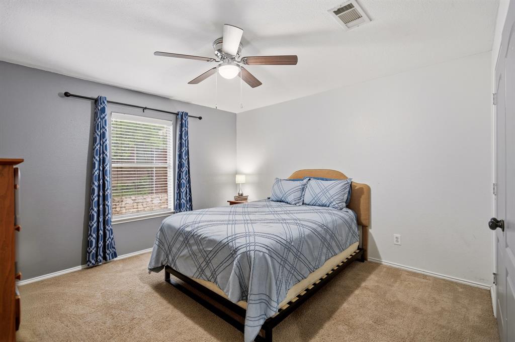 1213 Hampton Drive Forney, TX 75126 - Photo 7 of 27 a bedroom with a bed and window
