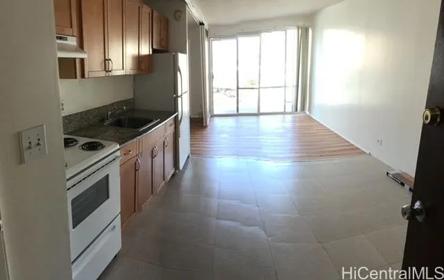 a kitchen with granite countertop a stove and a sink