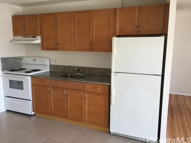a kitchen with a refrigerator and a stove