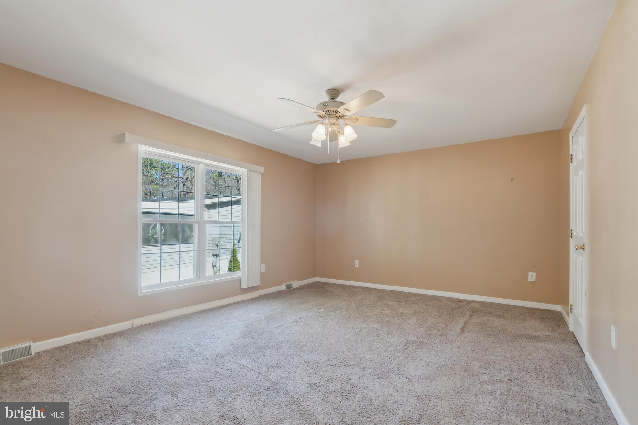 14 Skyline Drive Sicklerville, NJ 08081 - Photo 14 of 25 an empty room with windows and ceiling fan