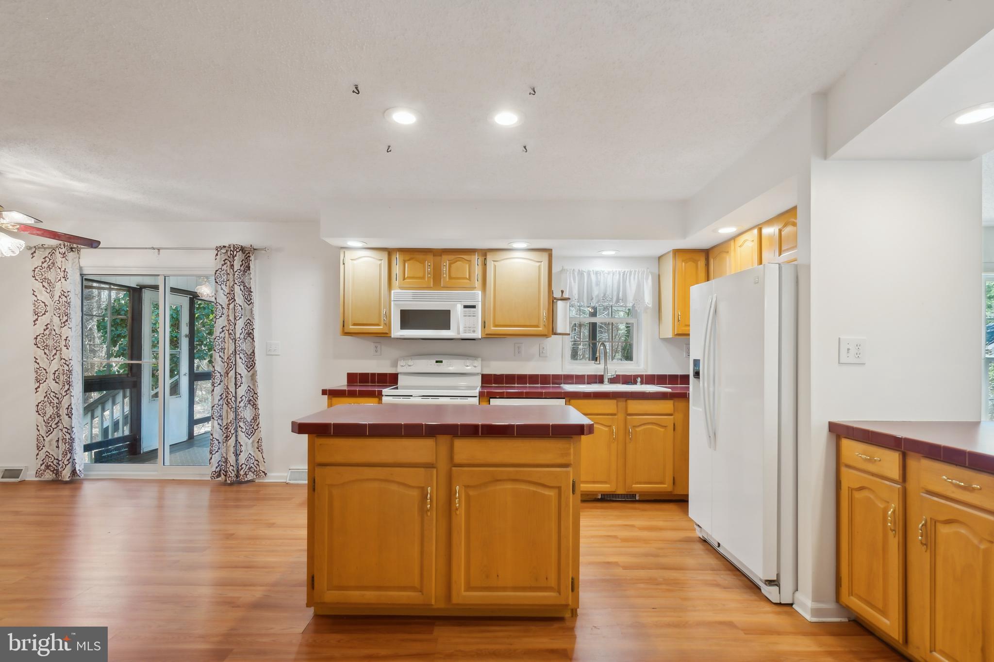 14 Skyline Drive Sicklerville, NJ 08081 - Photo 9 of 25 a kitchen with cabinets and wooden floor