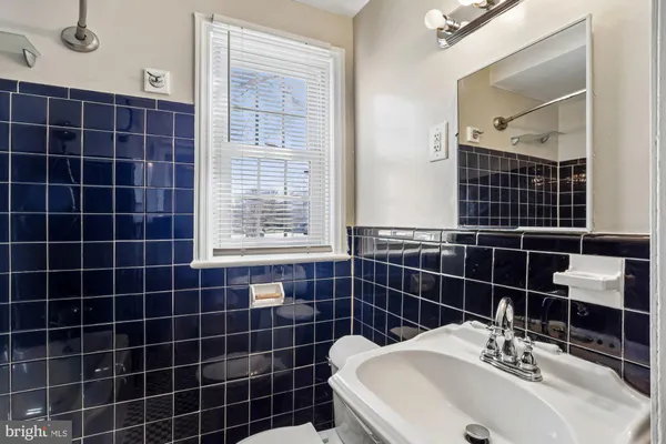 a bathroom with a sink toilet shower and a mirror