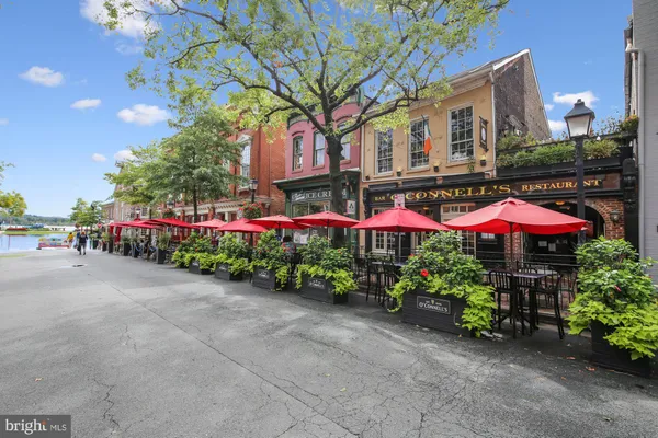a view of a cafe with a table and chairs under an umbrella