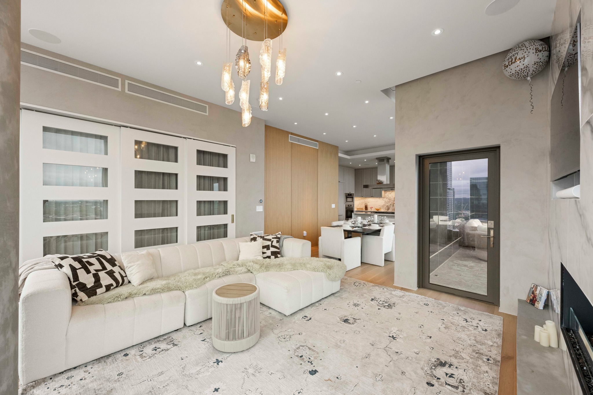 210 Lavaca Street, Unit 2706 Austin, TX 78701 - Photo 6 of 32 Living area featuring a contemporary chandelier, recessed lighting, and a neutral color palette