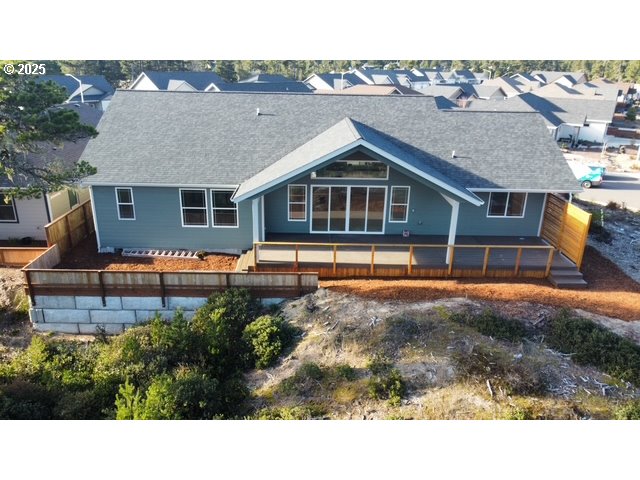560 Tournament Drive Florence, OR 97439 - Photo 2 of 7 a backyard of a house with table and chairs