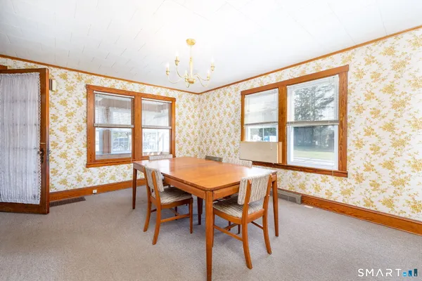 a dining room with furniture and windows