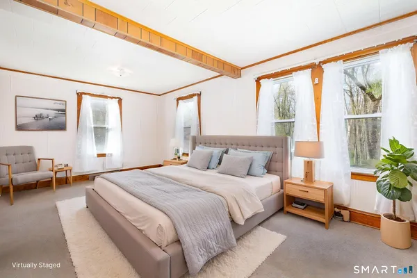 a bedroom with a balcony a bed and a couch