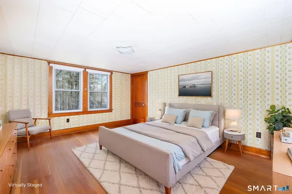 a bedroom with a large bed and a large window