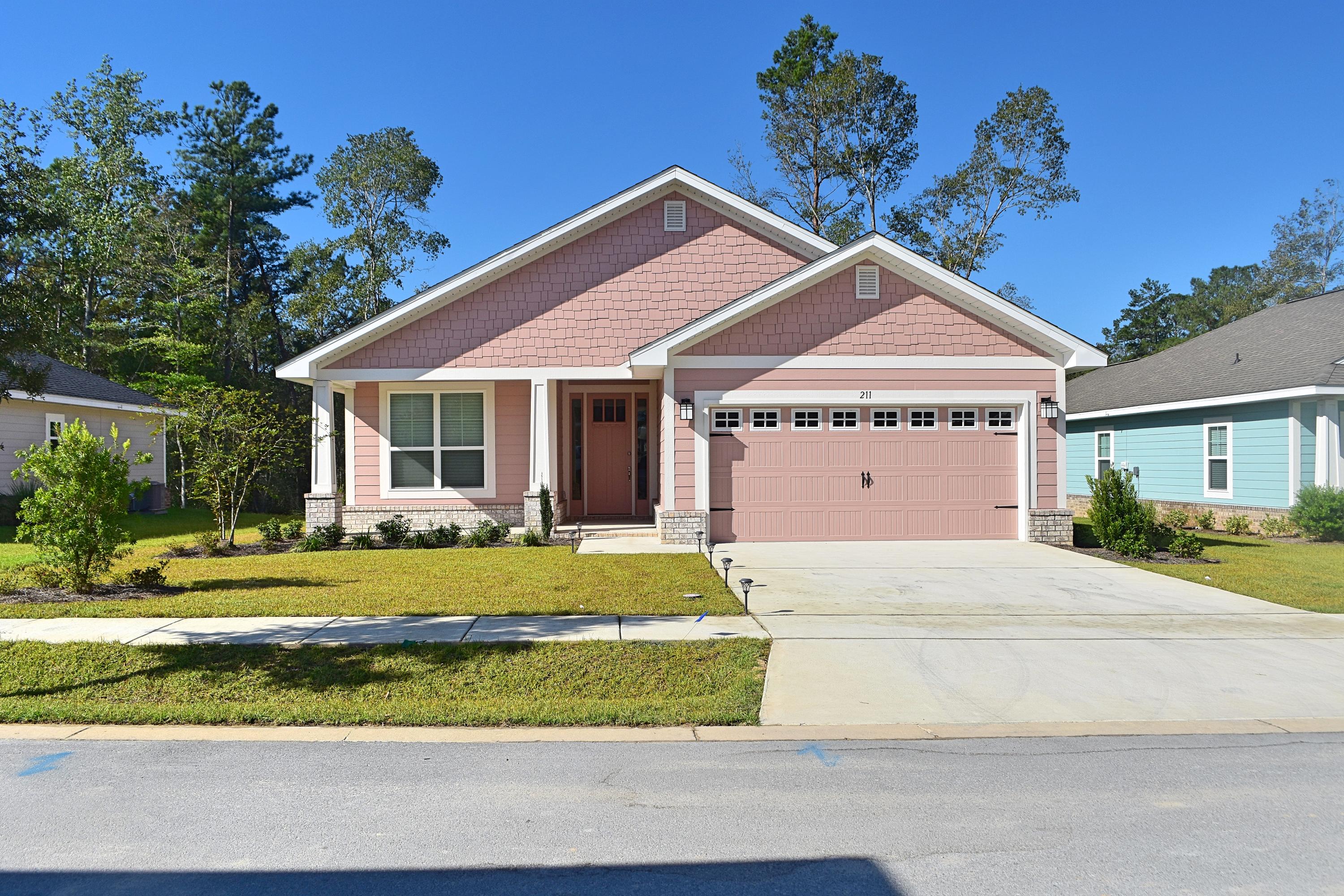 a front view of a house with a garden and porch