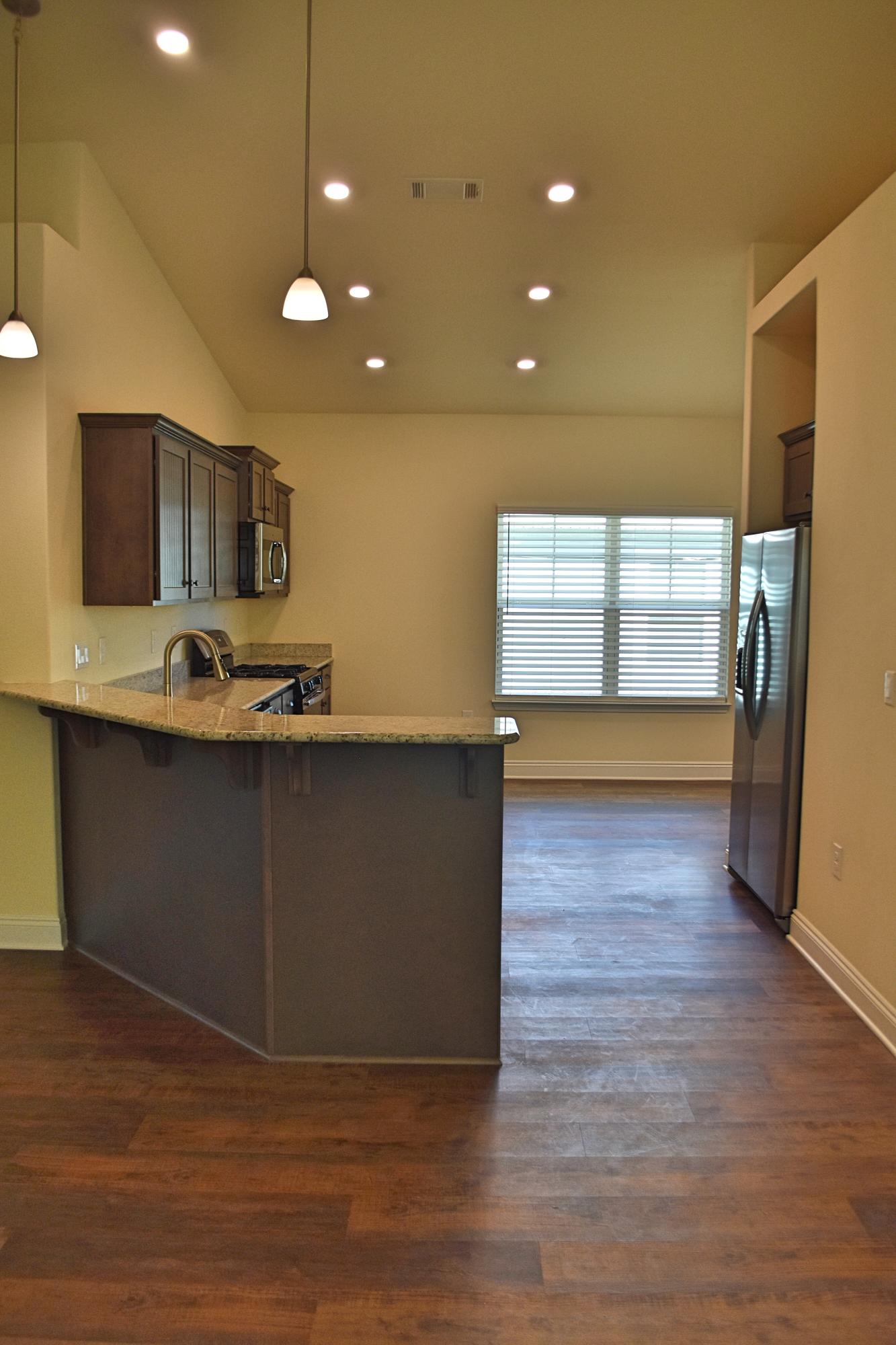 211 Brandywine Road Freeport, FL 32439 - Photo 13 of 37 a kitchen with stainless steel appliances granite countertop a sink a stove and a wooden floors