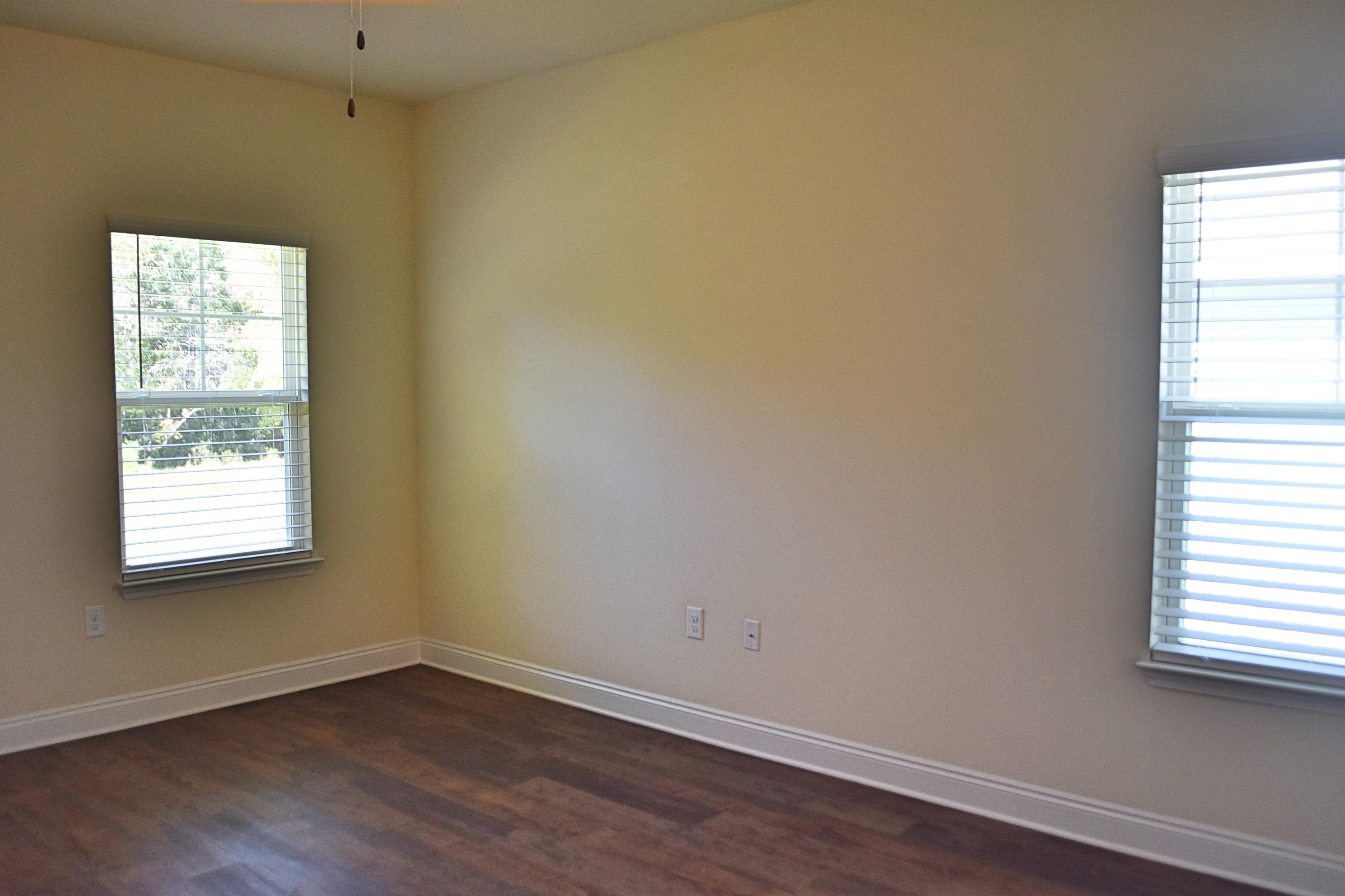 211 Brandywine Road Freeport, FL 32439 - Photo 26 of 37 a view of an empty room with wooden floor and a window