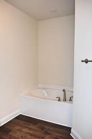a view of a white bath tub sitting in a bathroom