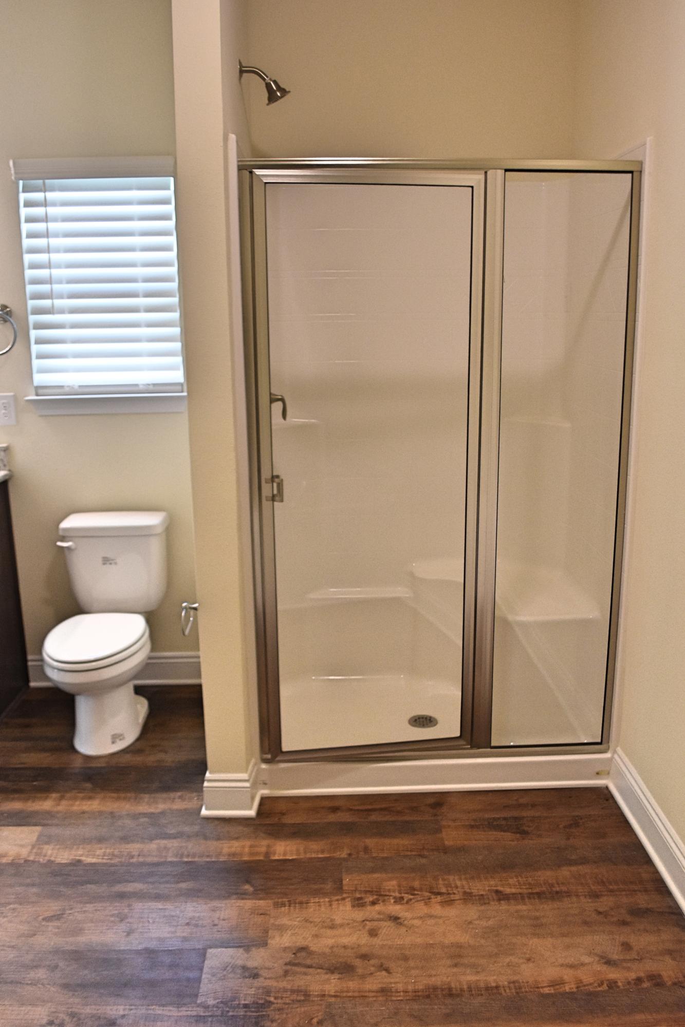 211 Brandywine Road Freeport, FL 32439 - Photo 32 of 37 a bathroom with a toilet a window and shower