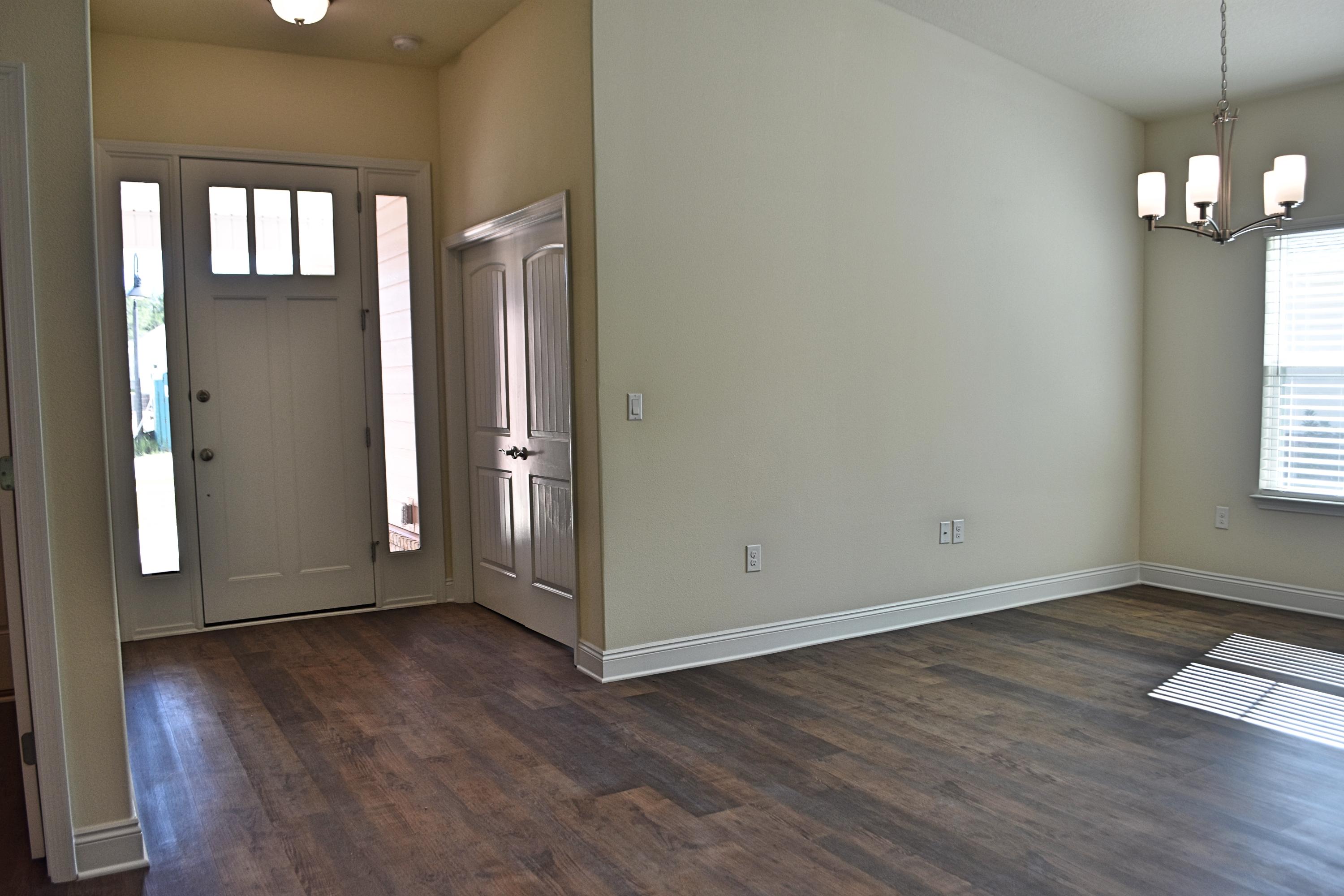 211 Brandywine Road Freeport, FL 32439 - Photo 5 of 37 an empty room with wooden floor and windows