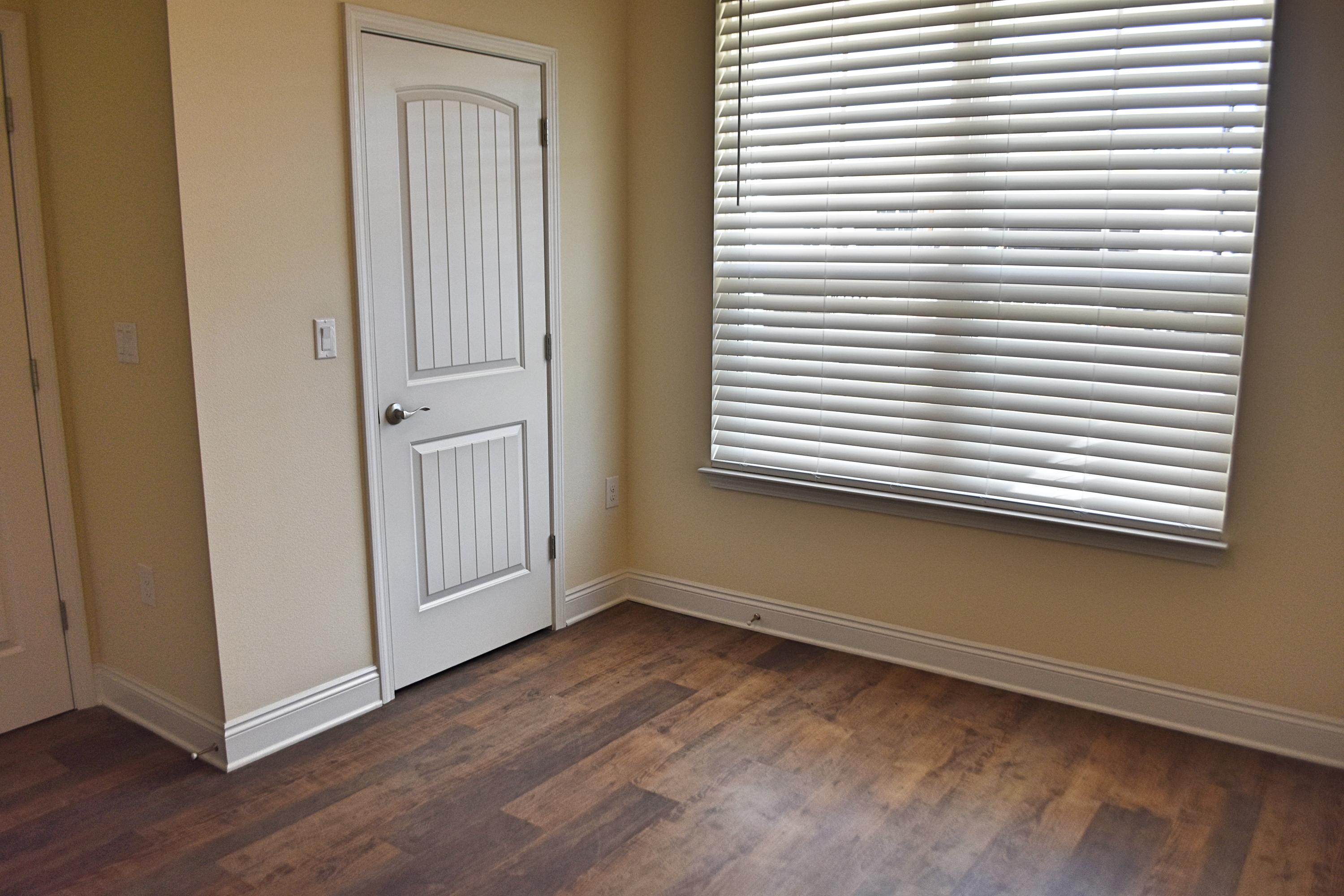 211 Brandywine Road Freeport, FL 32439 - Photo 7 of 37 an empty room with wooden floor and a window