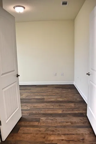 a view of an empty room and wooden floor