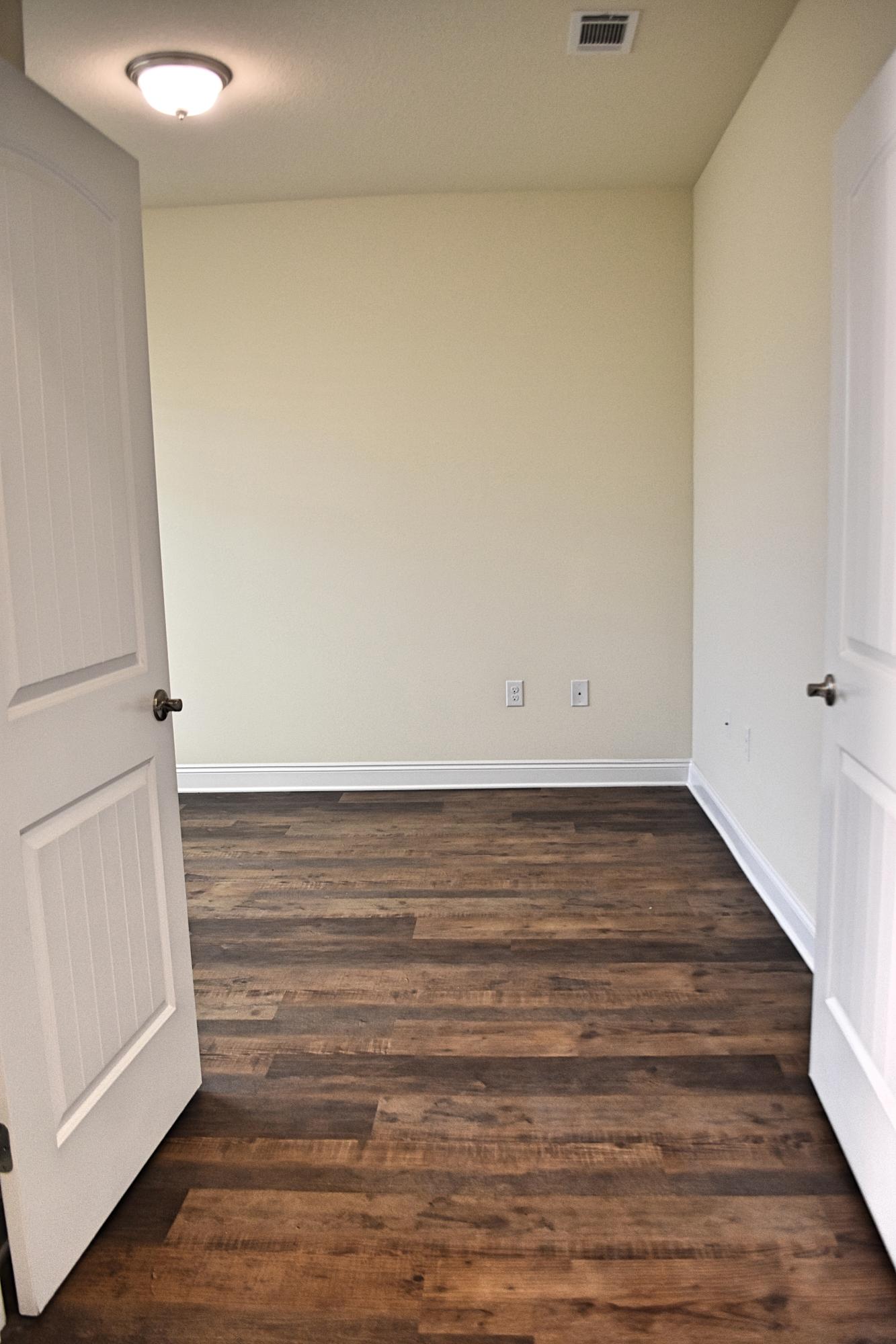211 Brandywine Road Freeport, FL 32439 - Photo 8 of 37 a view of an empty room and wooden floor
