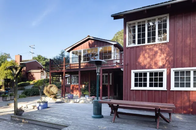 a front view of a house with outdoor seating