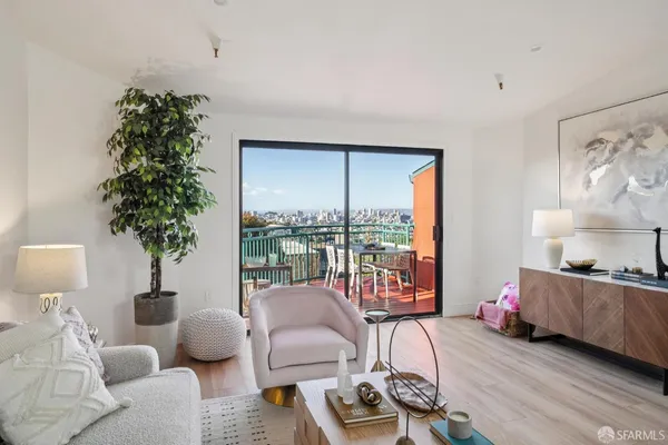 a living room with furniture and a potted plant