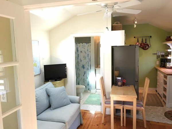 74 Hay Road, Unit 74 Eastham, MA 02642 - Photo 12 of 21 a living room with furniture a flat screen tv and a refrigerator