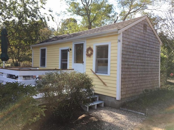 74 Hay Road, Unit 74 Eastham, MA 02642 - Photo 4 of 21 a view of a house with a yard