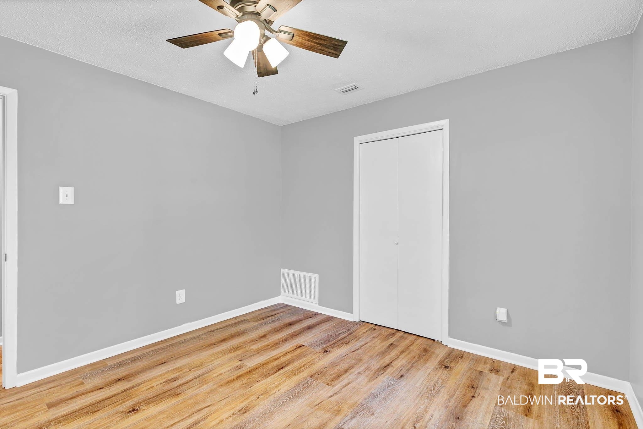 3304 Armond Drive Mobile, AL 36605 - Photo 37 of 62 Unfurnished bedroom with wood finished floors, a closet, and a ceiling fan