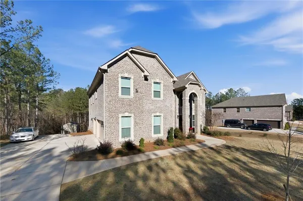 a front view of a house with a yard