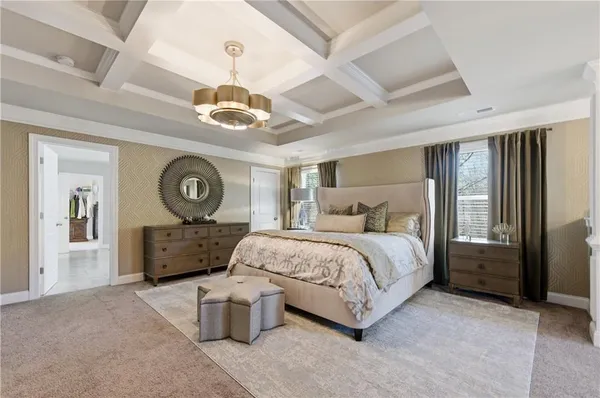 a spacious bedroom with a bed and a chandelier