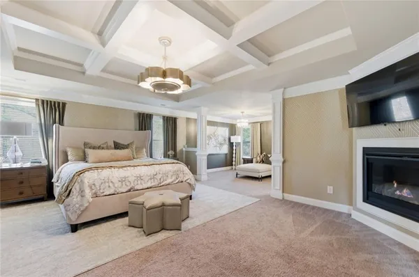 a spacious bedroom with a bed and a fireplace