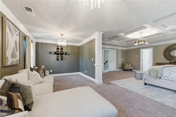 a spacious bedroom with a bed and ceiling fan