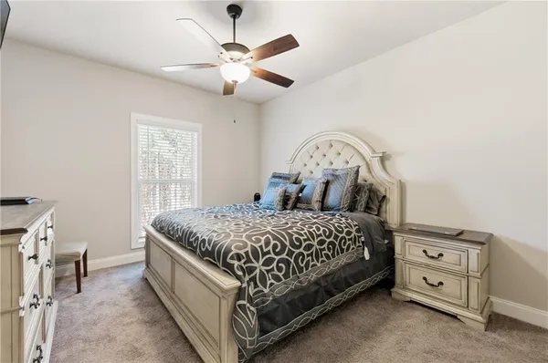 a bed sitting in a bedroom next to a window