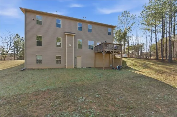 a view of a house with backyard and a tree