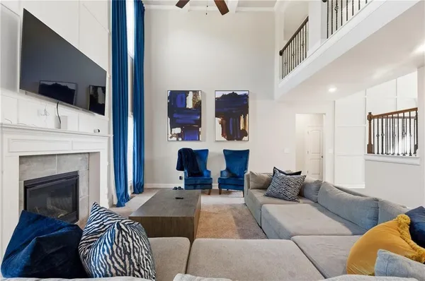 a living room with furniture a fireplace and a flat screen tv