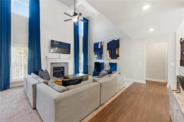 a living room with furniture a fireplace and a flat screen tv