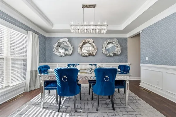 a view of a dining room with furniture and chandelier