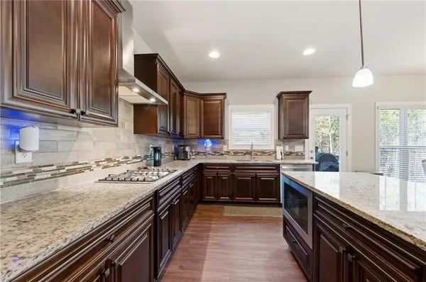 a kitchen with a sink stove top oven and cabinets