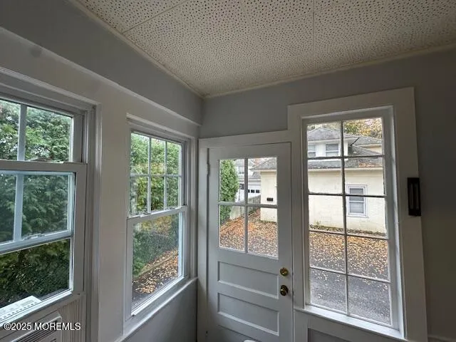 a view of wooden floor and windows in a room