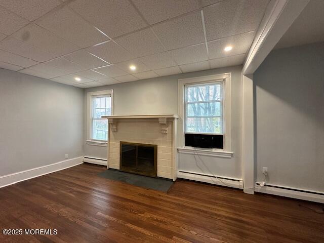 316 Spier Avenue, Unit 1 Allenhurst, NJ 07711 - Photo 7 of 9 an empty room with wooden floor a fireplace and windows