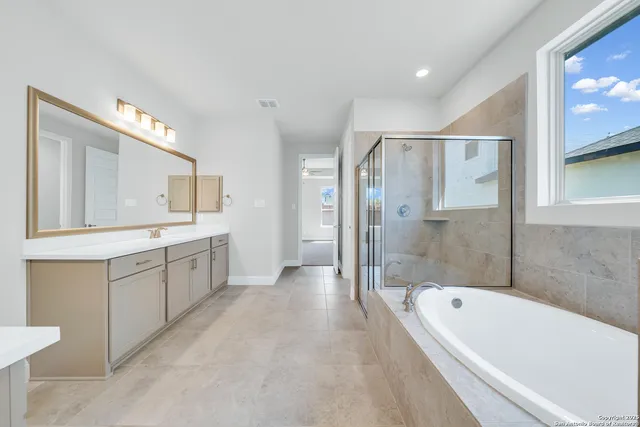 a bathroom with a bathtub shower and a sink